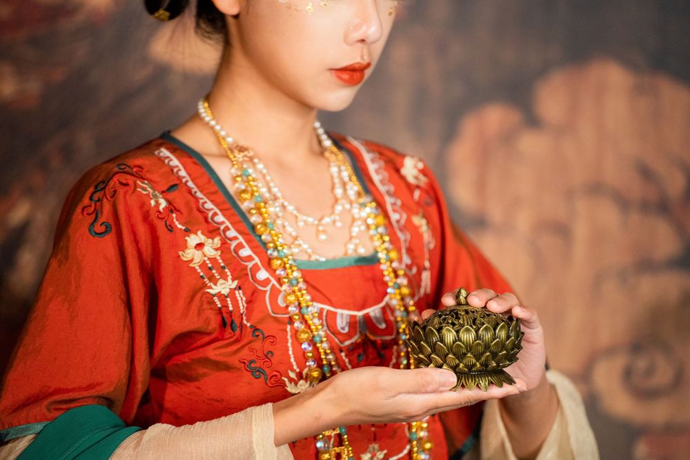 Cinematic solo portrait of divine Dunhuang Apsaras makeup in Tang Hanfu against a cave mural, by Imagine Image Studio Auckland.
