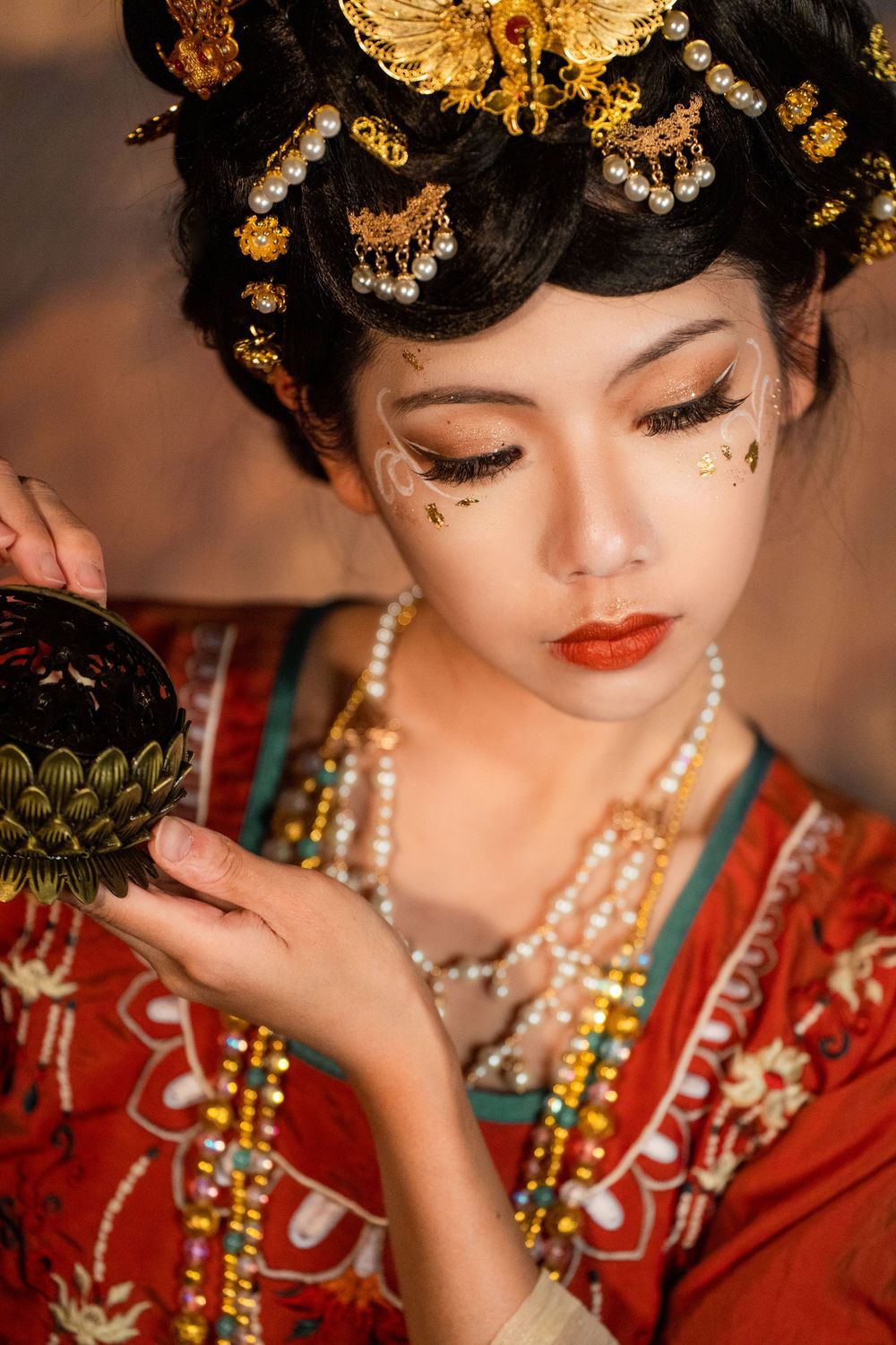 Cinematic solo portrait of divine Dunhuang Apsaras makeup in Tang Hanfu against a cave mural, by Imagine Image Studio Auckland.