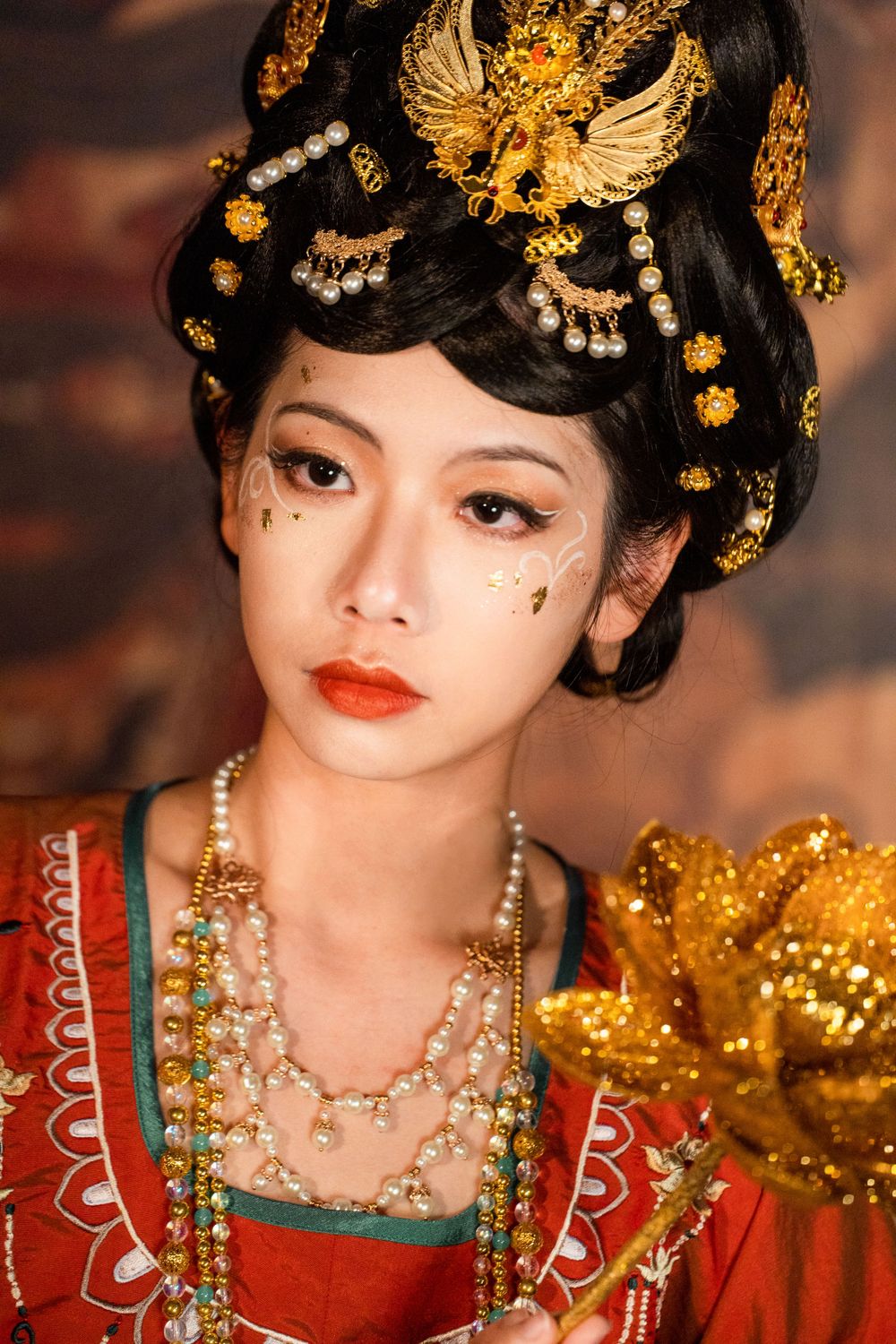 Cinematic solo portrait of divine Dunhuang Apsaras makeup in Tang Hanfu against a cave mural, by Imagine Image Studio Auckland.