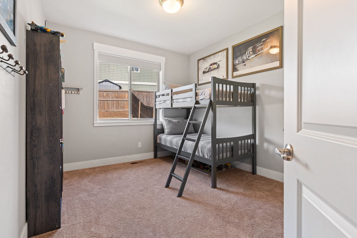 Cozy guest bedroom with bunk beds and natural light ideal for family or vacation home listings.
