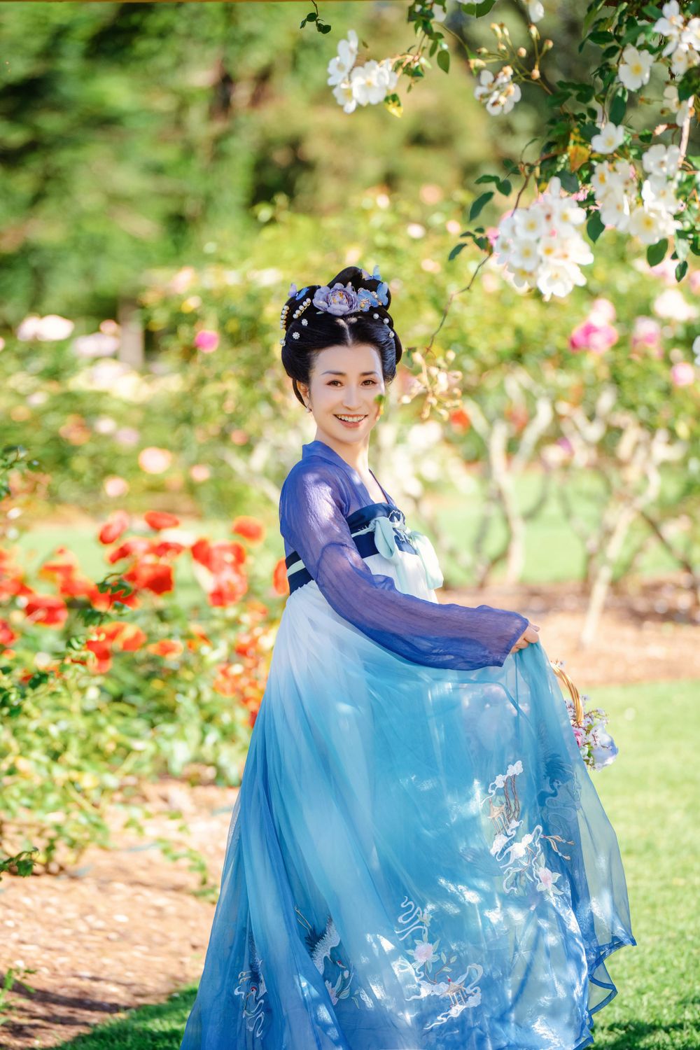 Dynamic natural sunlight portrait of a couple hugging and dancing in Tang Dynasty Hanfu among blooming roses, by Imagine Image Studio.
