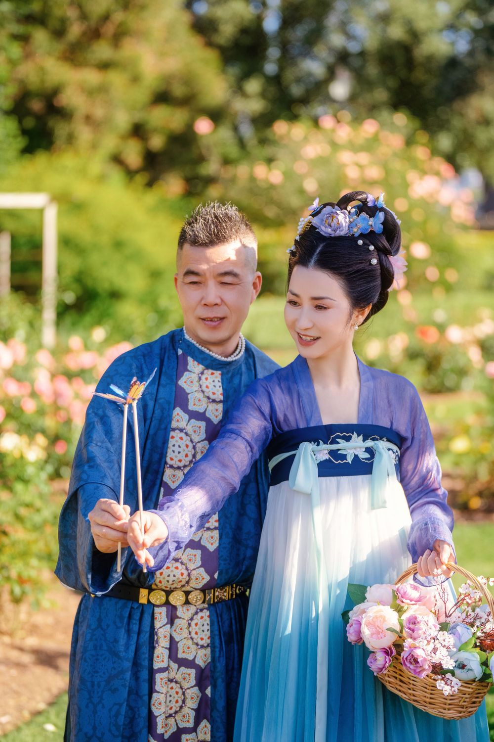 Dynamic natural sunlight portrait of a couple hugging and dancing in Tang Dynasty Hanfu among blooming roses, by Imagine Image Studio.