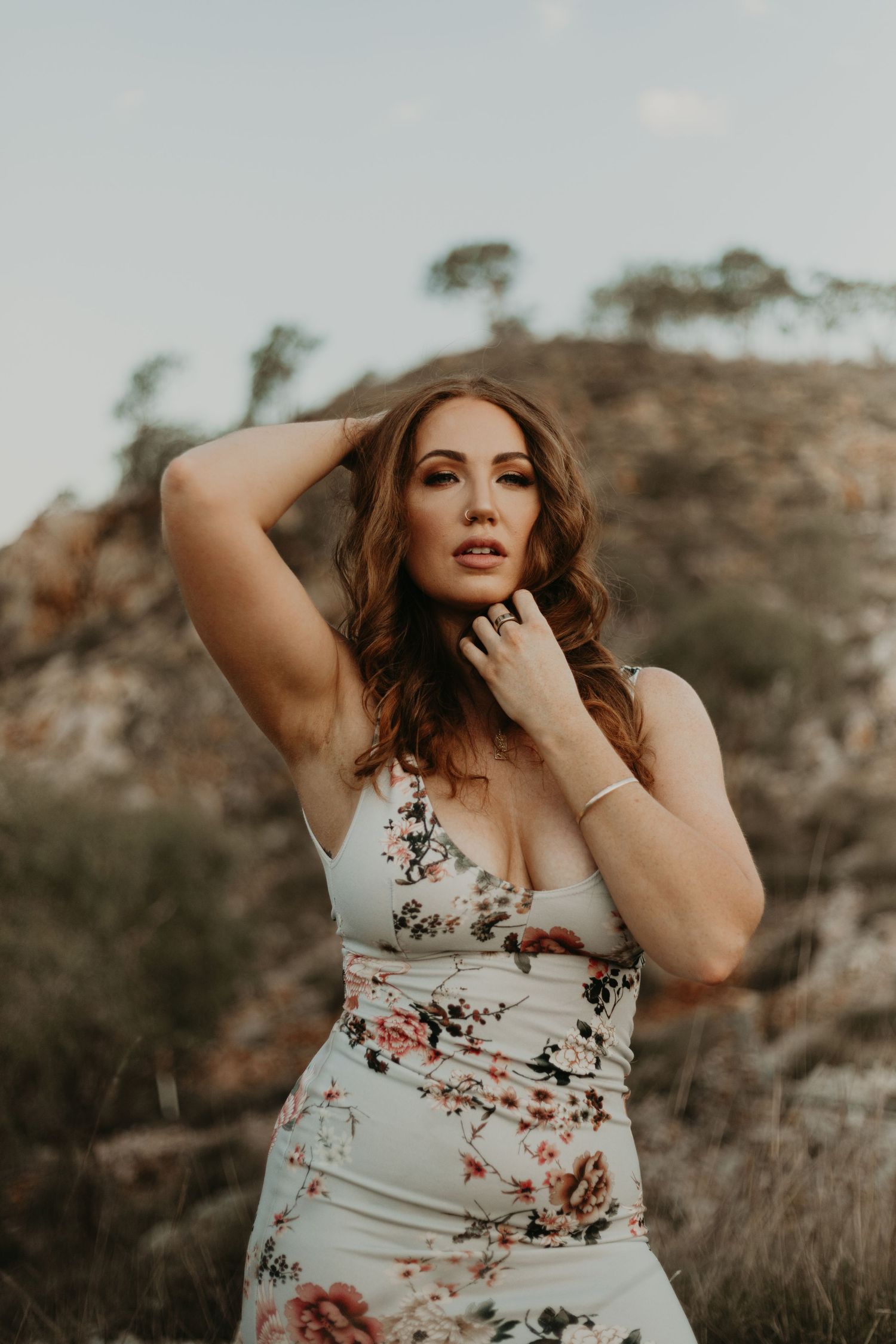 Woman posing with hand behind head and one under the chin
