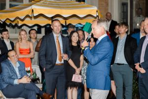 Keynote speaker addressing audience at Houston Company holiday event by Cypress business photographer
