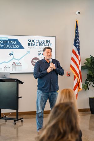 Keynote speaker addressing audience at Houston Company holiday event by Cypress business photographer