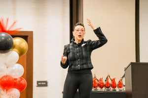 Keynote speaker addressing audience at Houston women's business event by Cypress business photographer