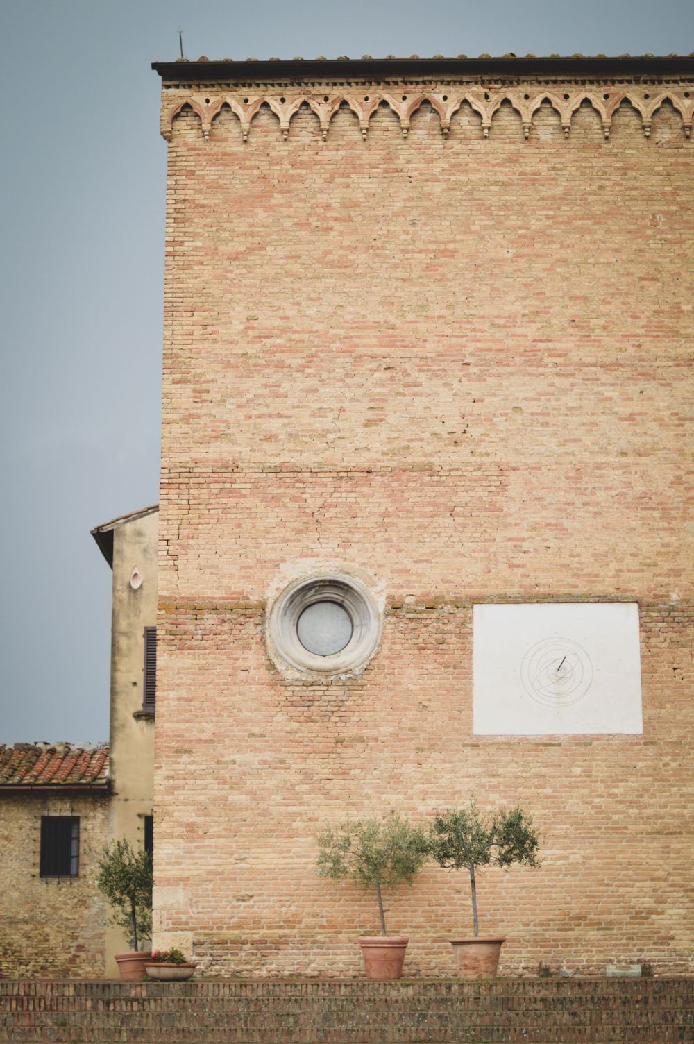 Gebäude aus rot-orangen Ziegelsteinen in San Gimignano in der Toskana.