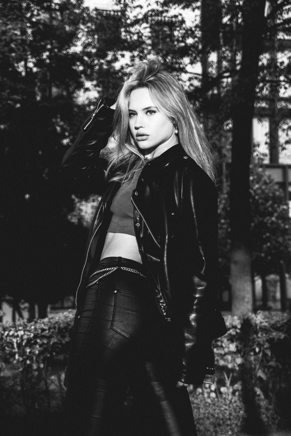 Moody black and white outdoor fashion photography with natural forest backdrop.