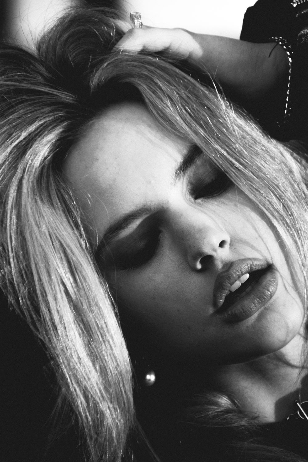 Dramatic black and white close-up portrait showing artistic emotion and texture.
