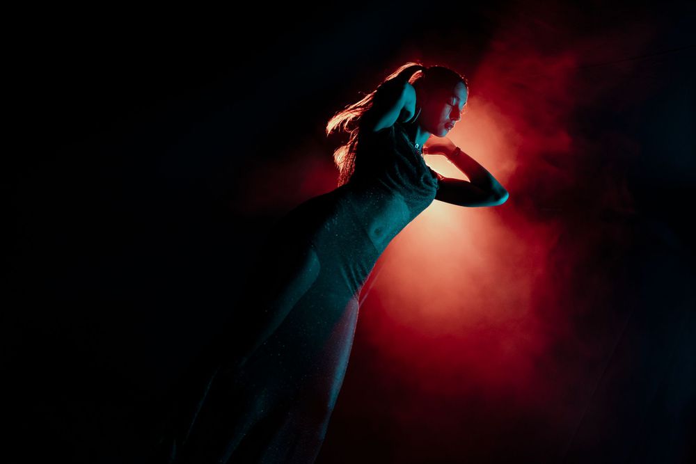 Artistic sequence with red lighting and camera equipment in dark environment.