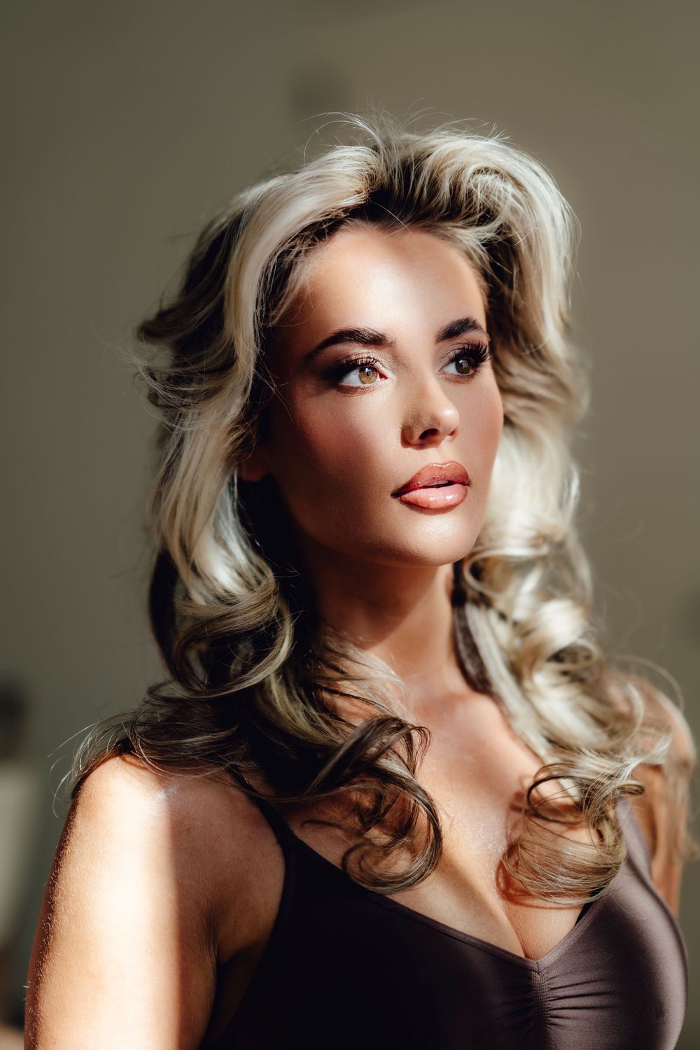 Glamour portrait of woman with vintage-style blonde curls and dramatic makeup.