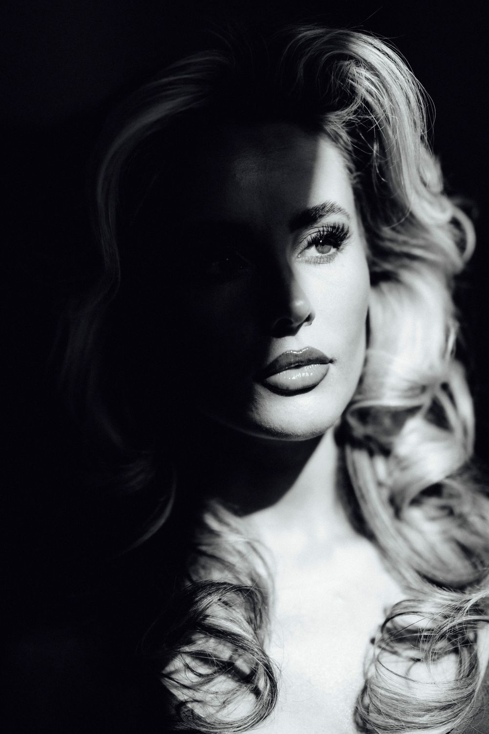 Artistic black and white portrait sequence with dramatic shadows and light contrast.