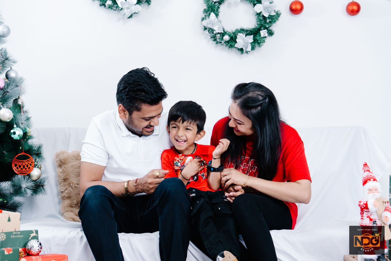 A family shares a joyful moment together during Christmas celebrations.