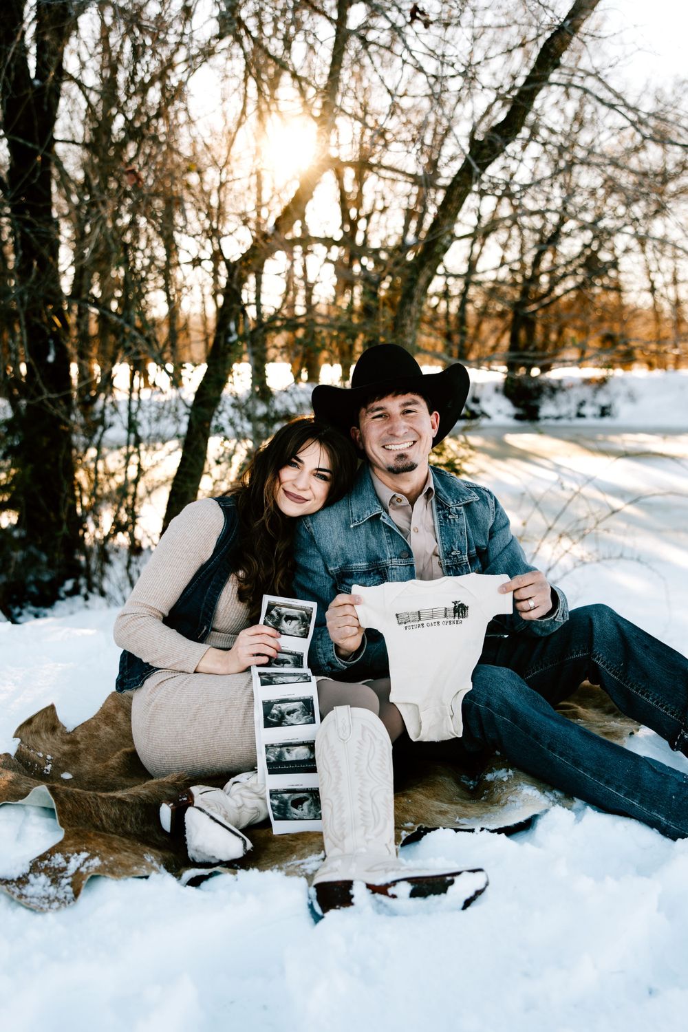 April Dirteater and Ryan Dirteater pose for their baby announcement photos on their family ranch in the snow in Hulbert, Oklahoma.