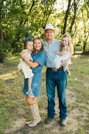 A cowboy and his family of four pose for their spring 2026 family photos on their family ranch in Council Hill, Oklahoma.