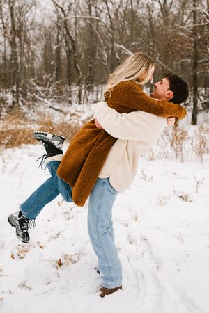 A couple pose for photos during a portrait session in the snow in Tahlequah, Oklahoma.