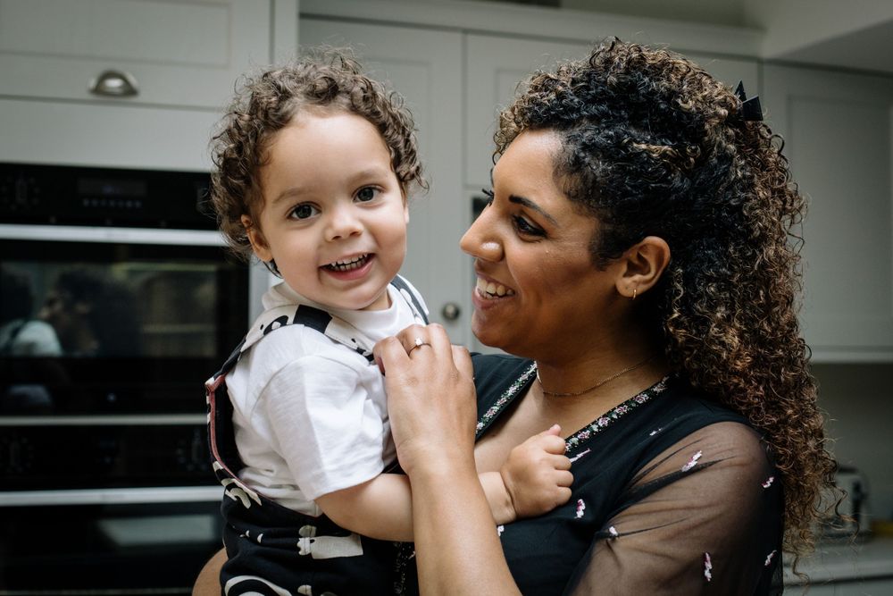 Heartwarming kitchen scene showing affectionate interaction between parent and child.