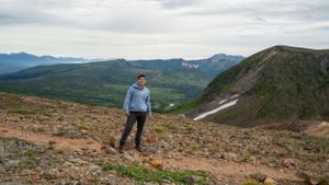 Scenic mountain hiking trail offers sweeping views of valleys and distant peaks.