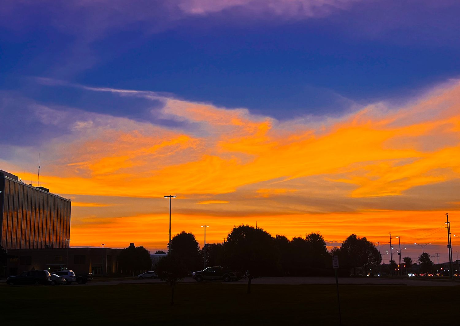 A stunning sunset sky with vibrant orange and purple clouds stretches across multiple panoramic views.