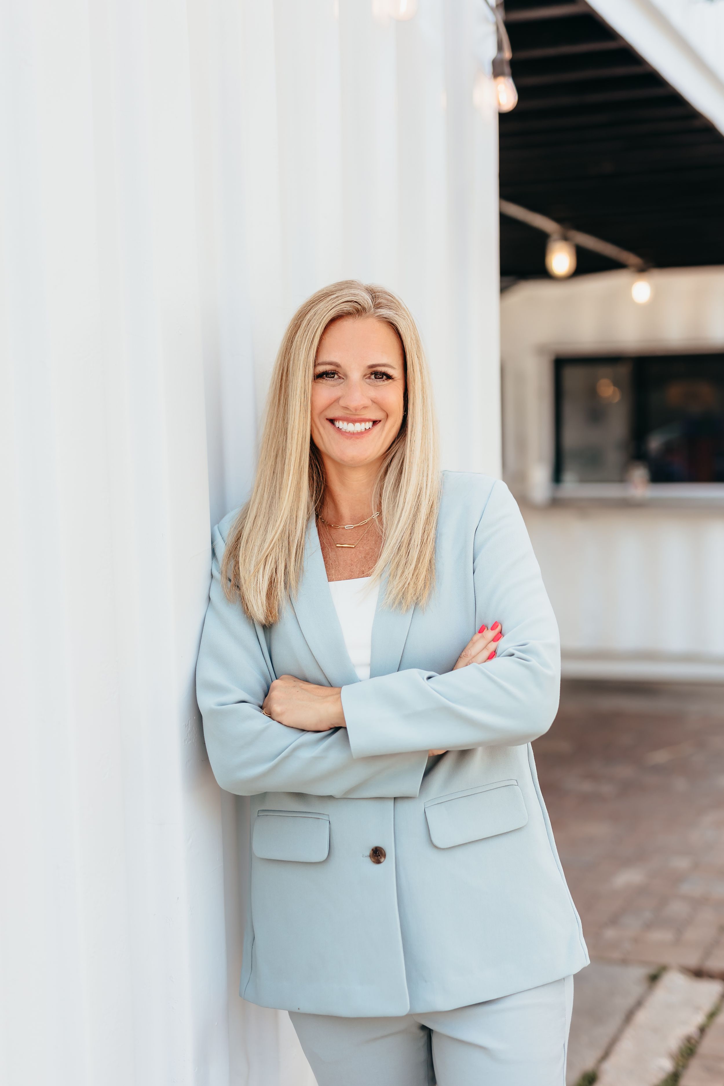 Professional headshots of woman in light blue blazer against white modern backdrop.