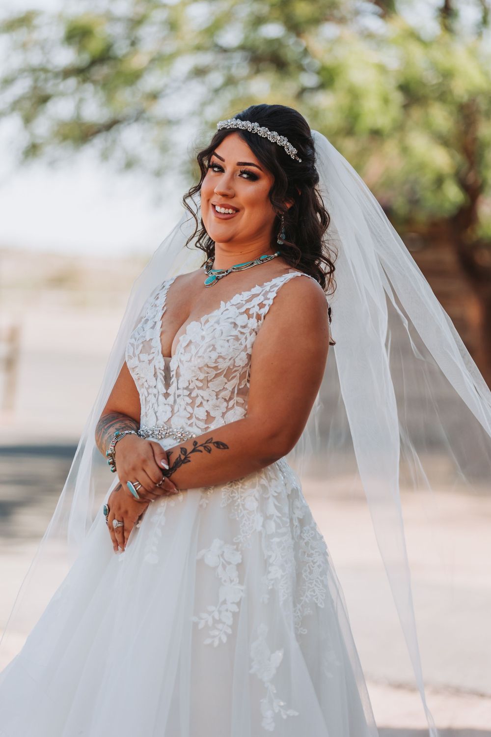 Bridal portrait featuring lace wedding dress with crystal headpiece and veil.