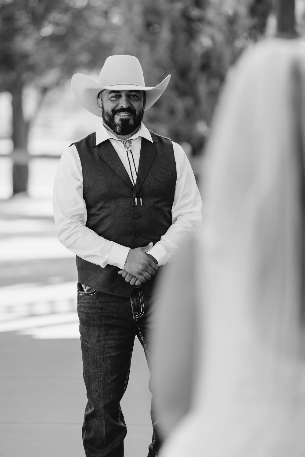 Black and white portrait of person in western attire.