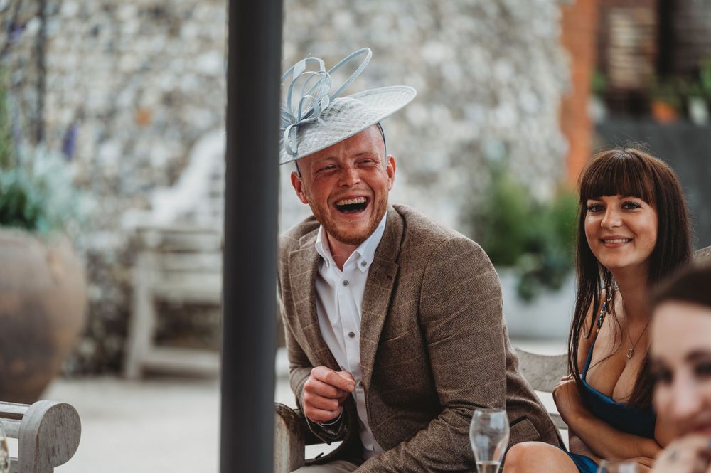 Wedding guests enjoying lively conversation during reception celebration.
