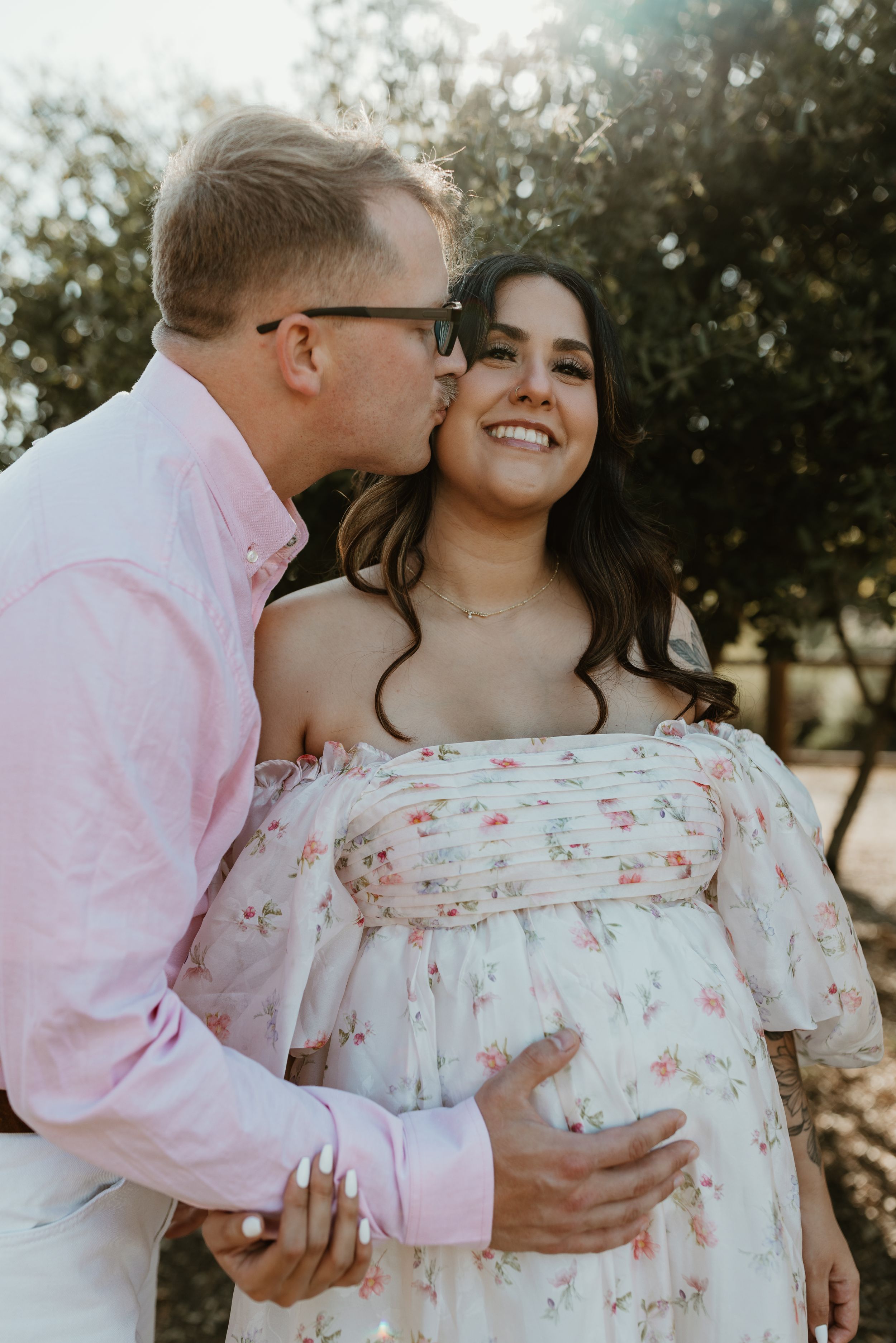 feeling the baby bump with a cheek kiss