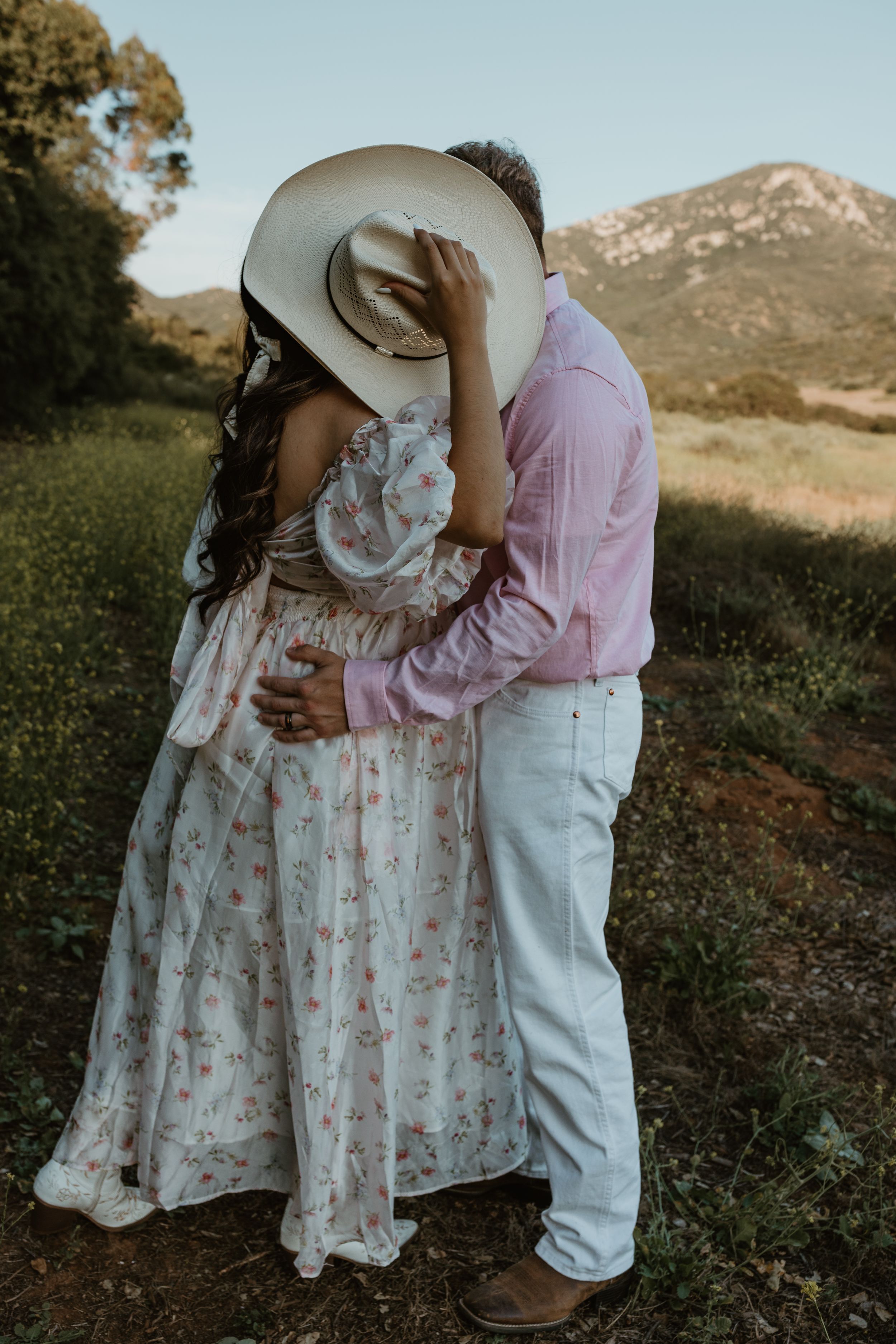 hiding a kiss behind the cowboy hat