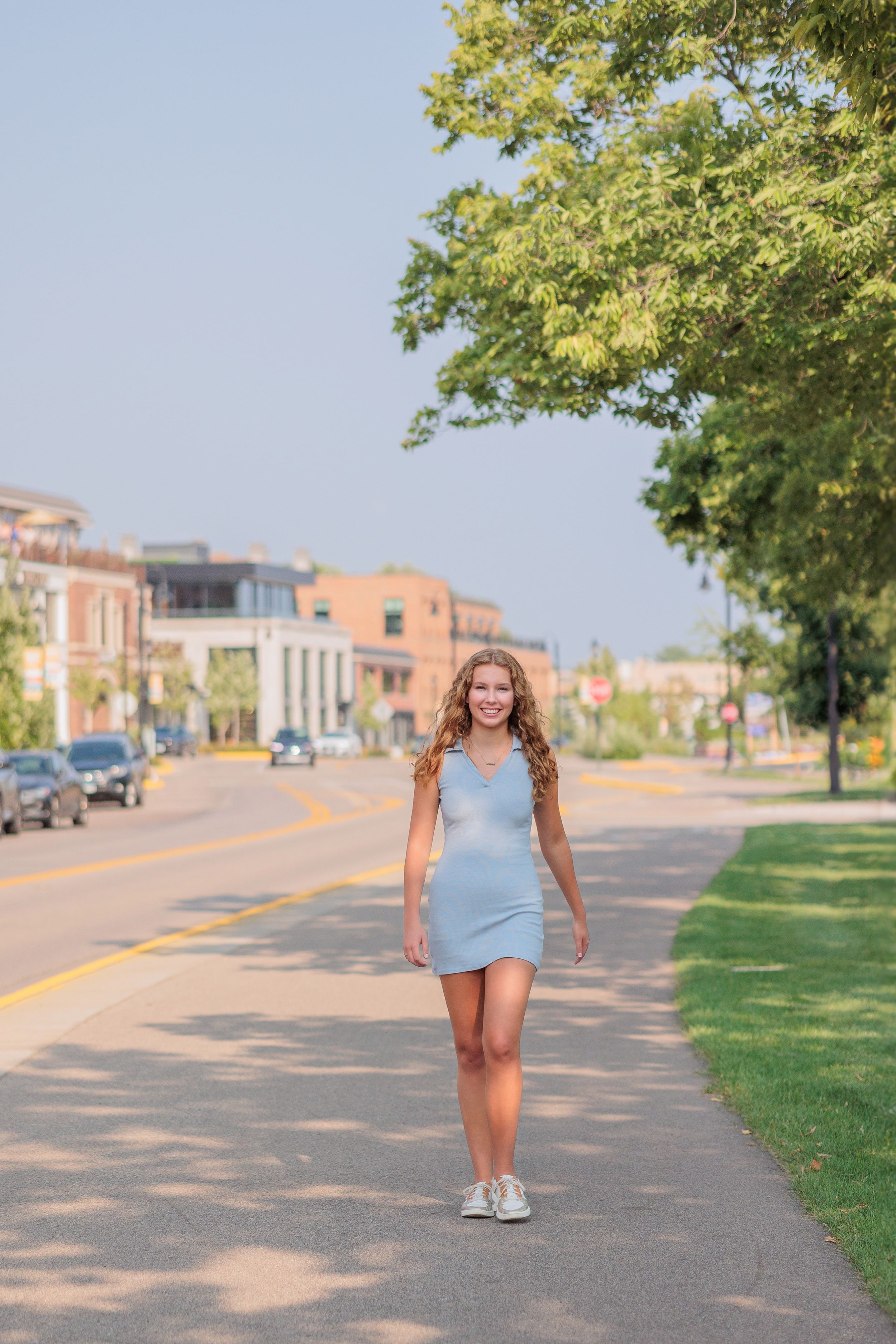 High school senior portrait walking in downtown Wayzata