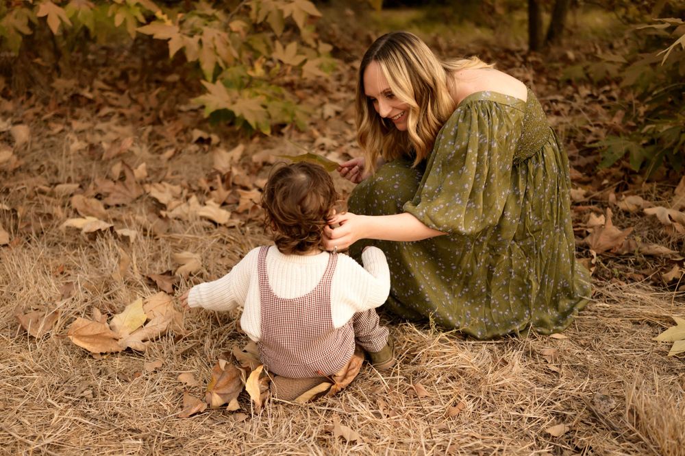 Mommy and me photoshoot in Thousand Oaks of in golden field exploring with her toddler son in oak tree leaves by Ventura photographer