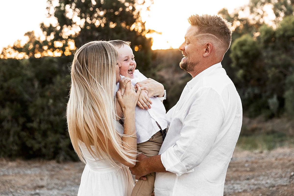 Family photographer Adelaide — parents and children laughing together outdoors, natural light lifestyle session — Photo By Nancy