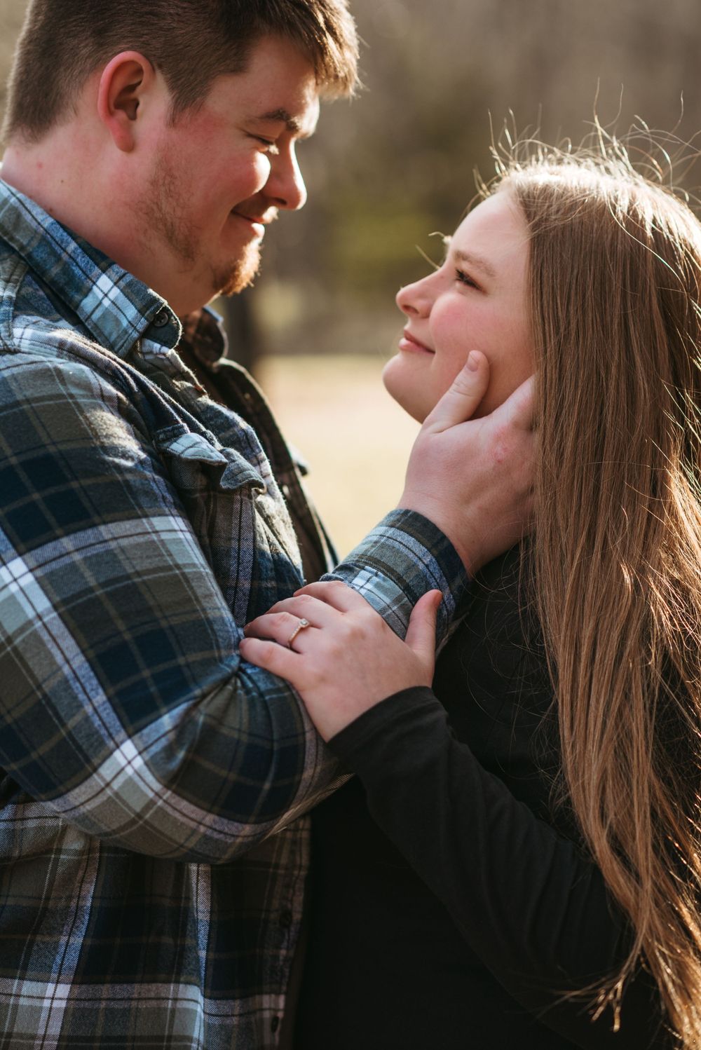 Close up shot of couple sharing an intimate romantic moment in warm lighting.