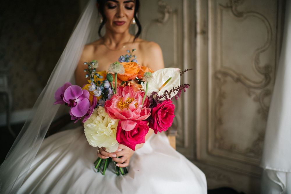 A series of wedding photos showing elegant bridal bouquets with vibrant pink, orange, and purple flowers in a luxurious setting.