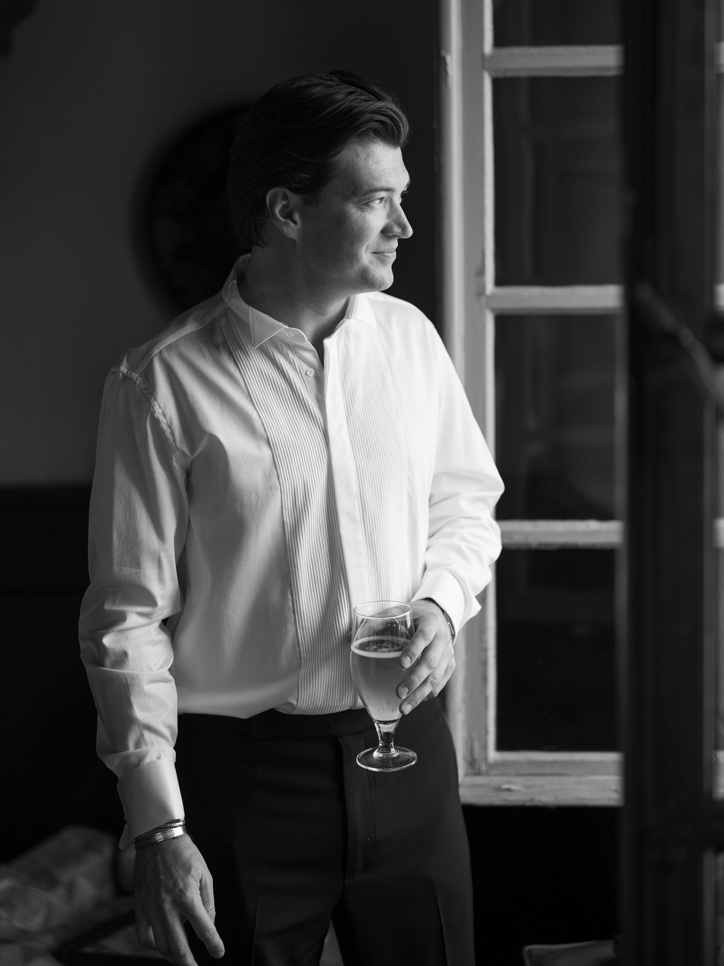 Dramatic black and white portrait of formal attire and stemware.