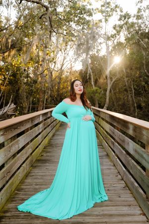 Sunlit Maternity Photo on Nature Bridge | Emotional Family Photography in Natural Light