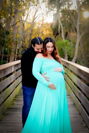 Sunlit Maternity Photo on Nature Bridge | Emotional Family Photography in Natural Light