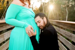 Sunlit Maternity Photo on Nature Bridge | Emotional Family Photography in Natural Light