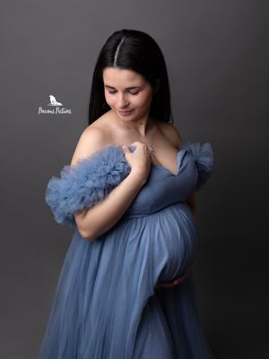 Elegant studio maternity portrait in a soft blue off-the-shoulder tulle dress, captured by Precious Pictures photography, Malta