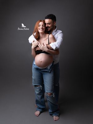 Joyful couple maternity photoshoot in studio, candid laughing moment, Precious Pictures Malta.