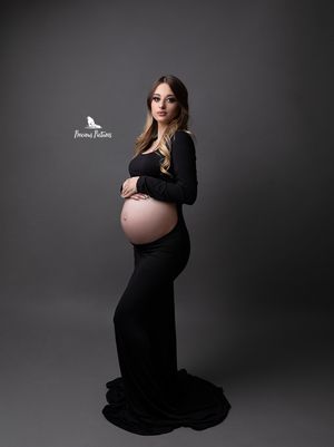 Sleek studio maternity portrait in a black long-sleeved dress, professional pregnancy photography by Precious Pictures, Rabat, Malta.