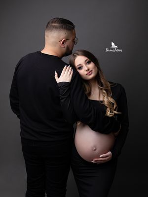 Modern studio maternity portrait of a couple in black attire, professional pregnancy photography by Precious Pictures, Rabat, Malta.