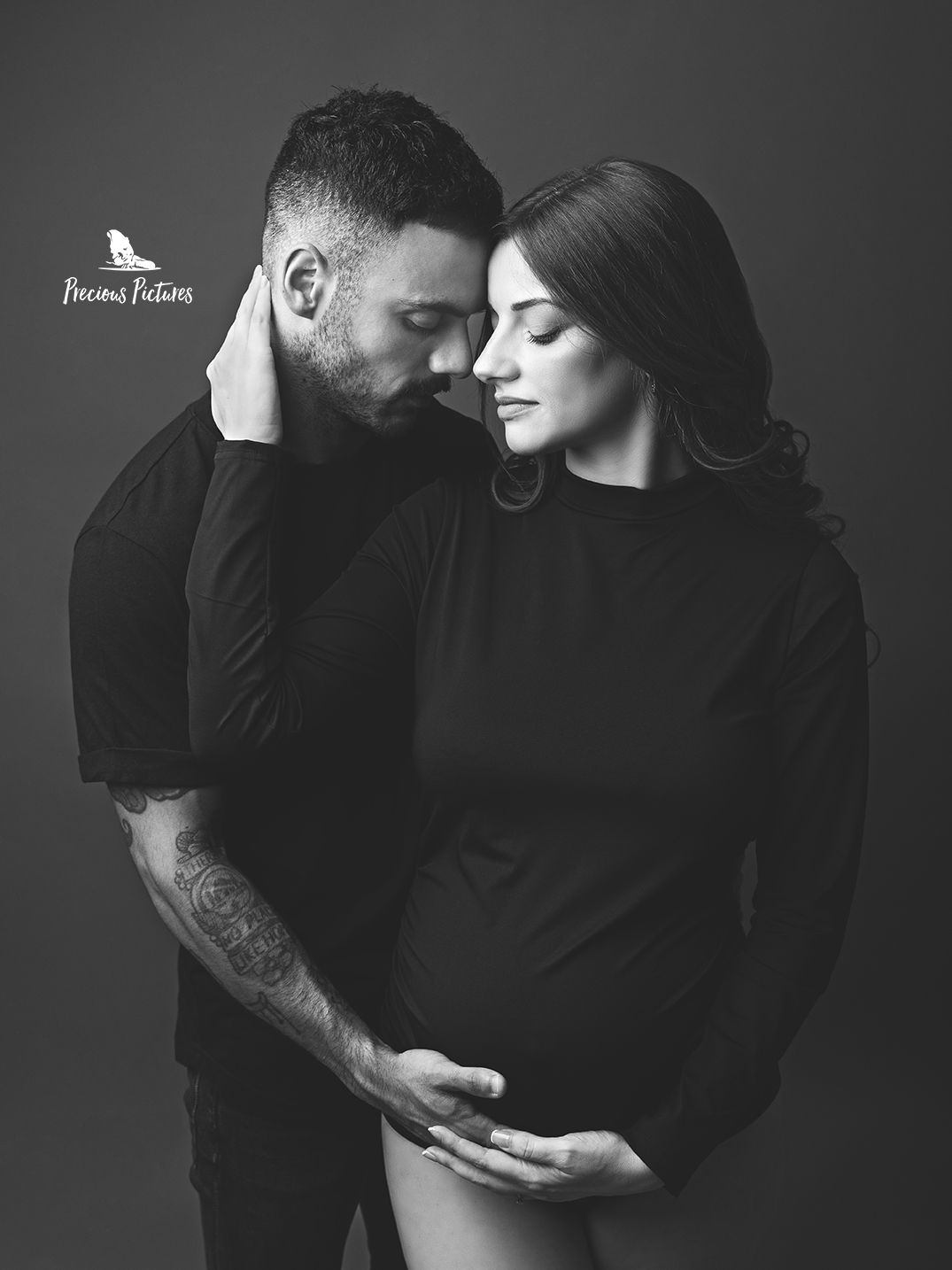 Intimate black and white couple maternity photoshoot in Malta, father-to-be touching baby bump, maternity photography by Precious Pictures