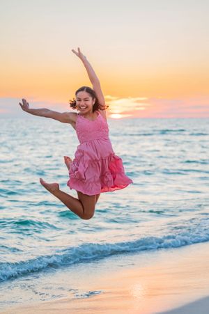 senior jumping during photo session on Panama City Beach