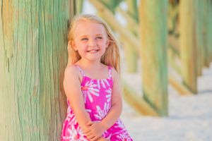 Little girl posing by pier on Panama City Beach