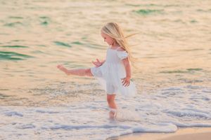 Little girl playing in the water on beach Panama City Florida