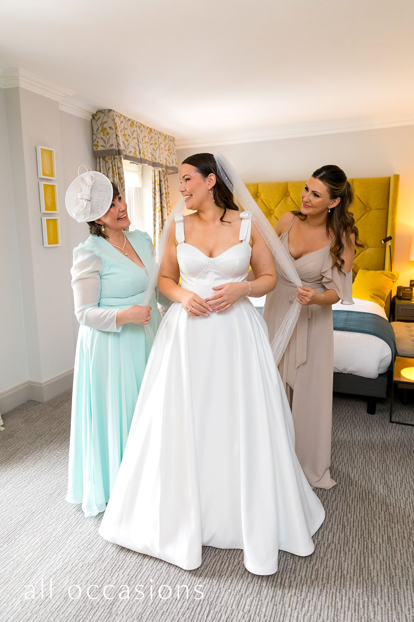 Bride with Mum and Maid of Honour during bridal preparations at the Bush Hotel, Farnham