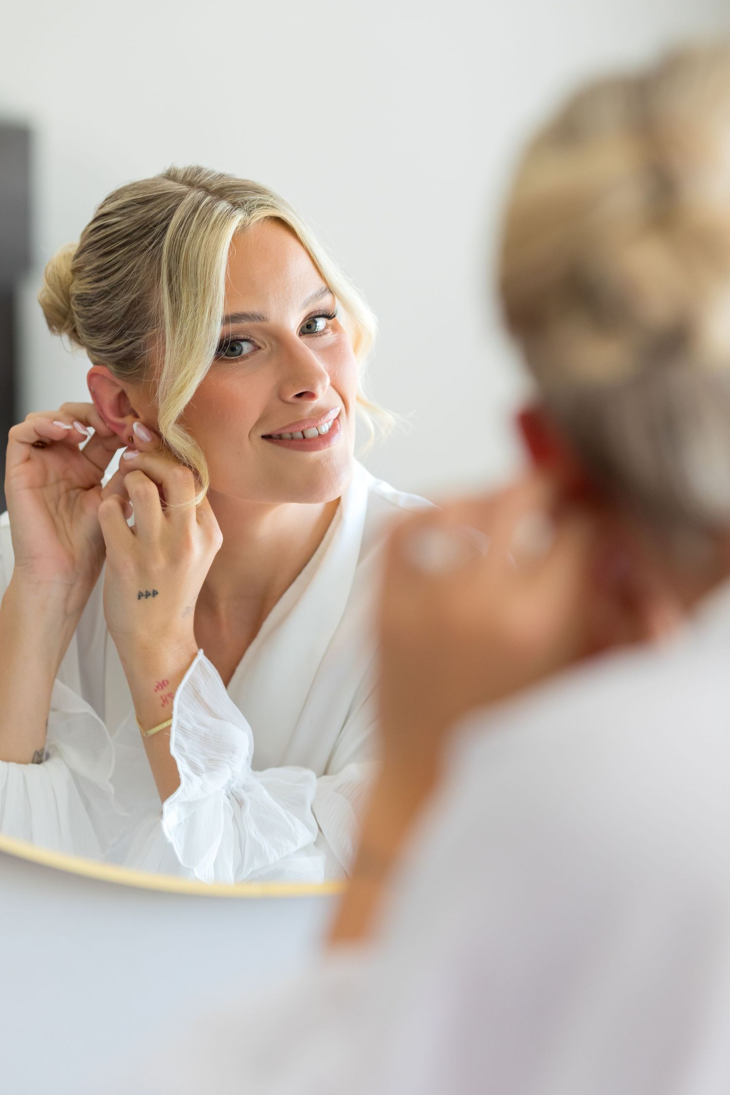 Bride putting her earings on at Orange Grove Hotel, Coldeast