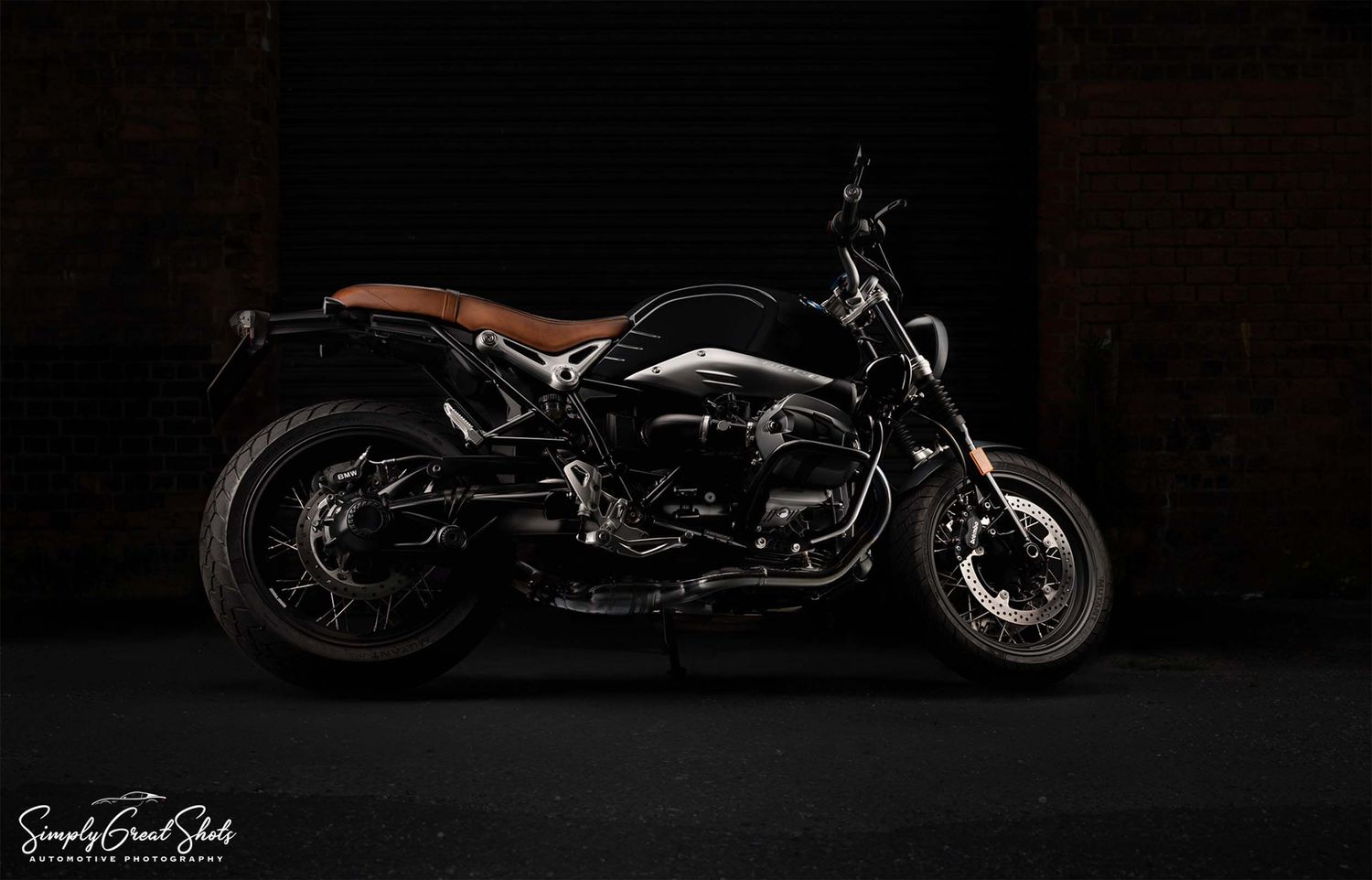 A light painted BMW NineT motorcycle with a dark background