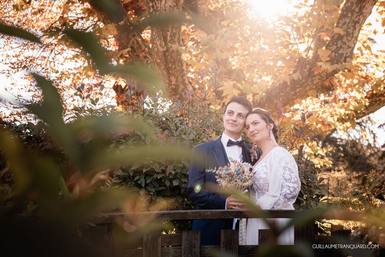 Romantic autumn photoshoot with golden sunlight filtering through trees.